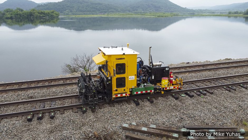 The tie plate inserter raises the rails and slides the tie plates into position, and lowers the rails onto the tie plates. Racine Railroad Products developed its first tie plate inserters in the early 2000s; this, the Advanced Tie Plate Inserter (ATPI) was introduced in 2017. 