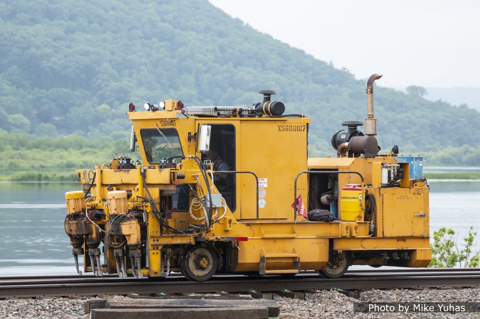 This tamper squeezes ballast under the ties to provide s strong and stable foundation for the track structure. This machine did not appear to be working, at least not in front of our reviewing stand.